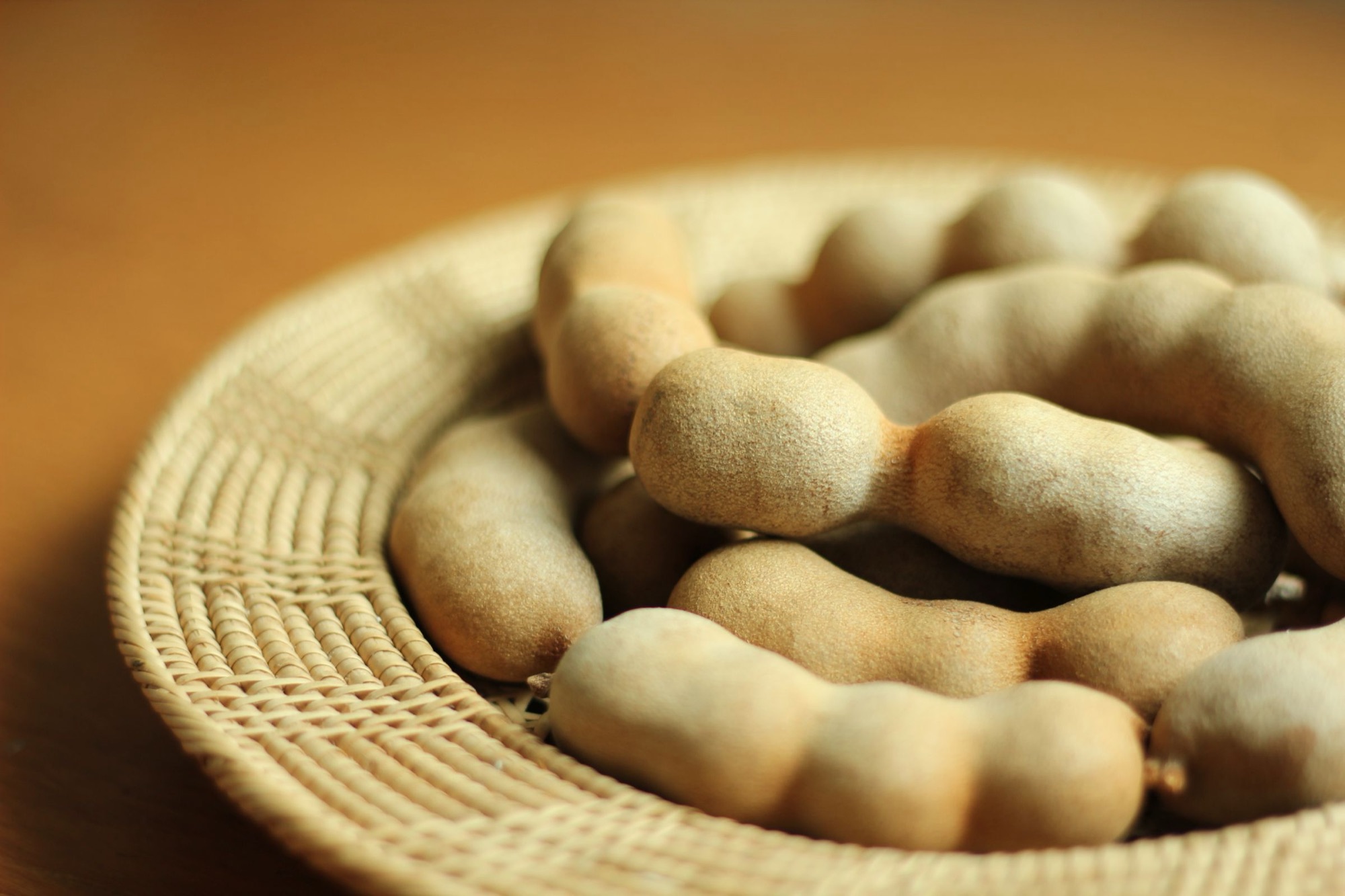 Tamarind pods in a woven basket